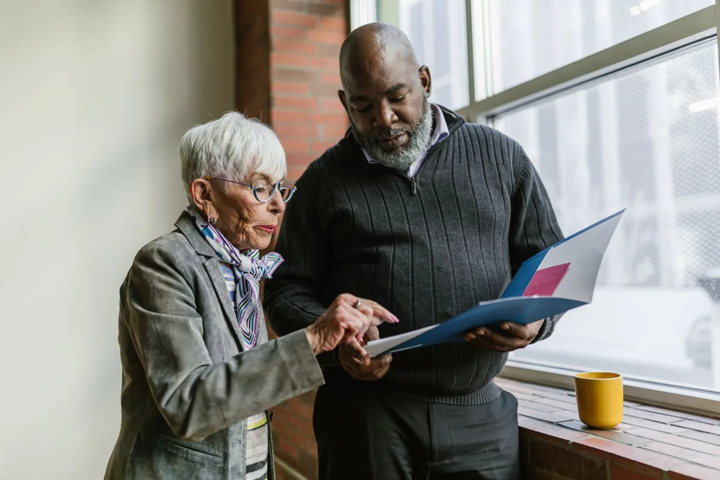 Two experienced professionals reviewing evidence together