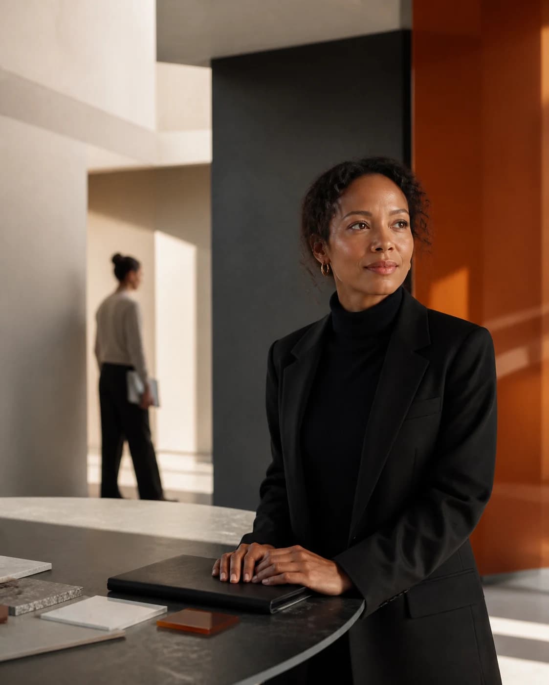 A technology leader standing confidently in a refined architectural workspace